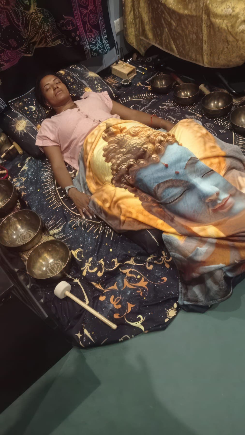 A guest lying at rest among the singing bowls