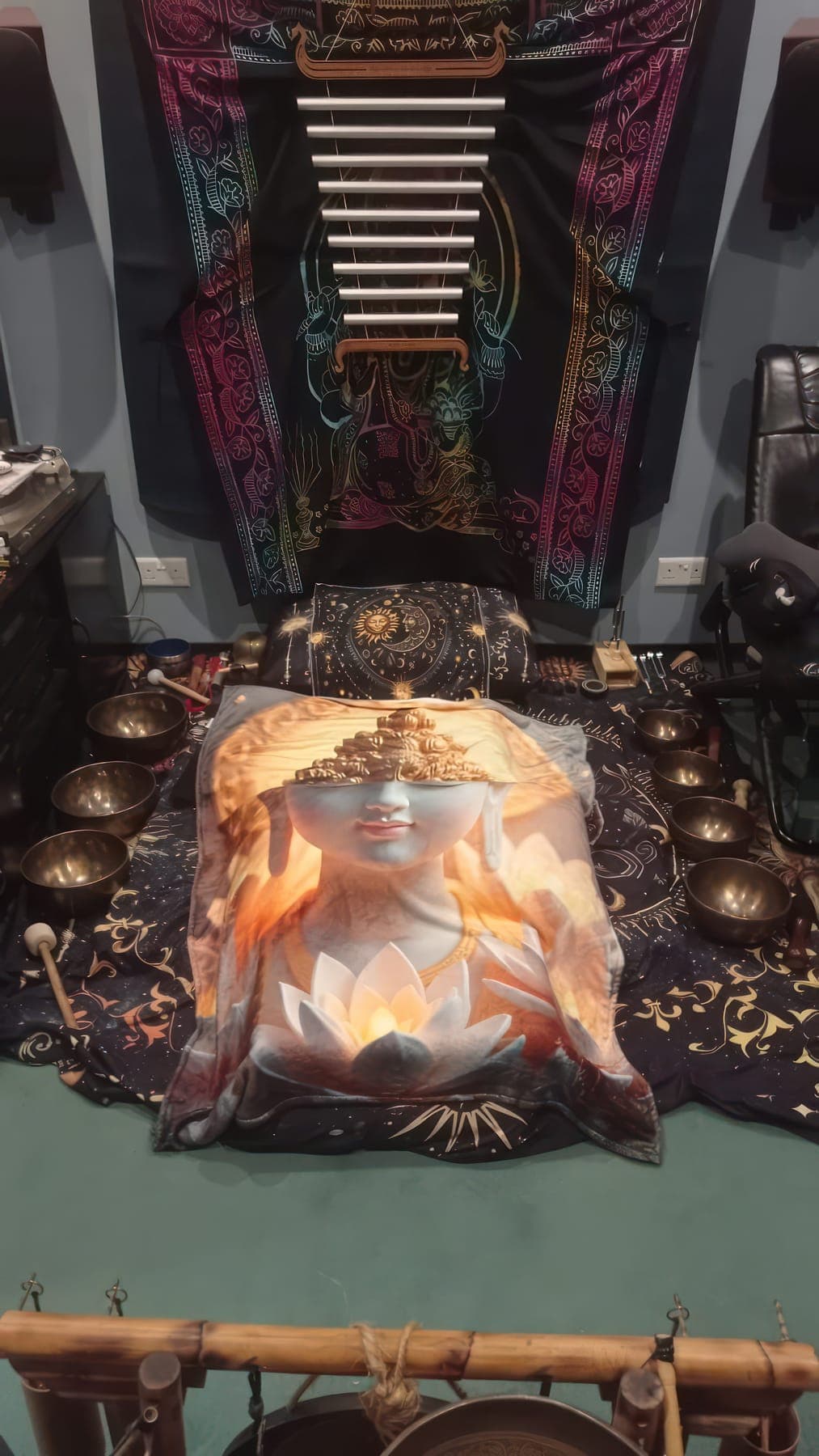 The sound room prepared for a guest: a resting place surrounded by singing bowls and chimes